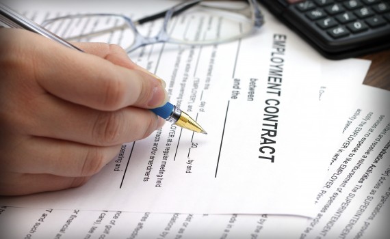 picture of woman signing employment agreement