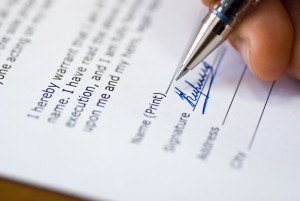 Close up on a hand signing a contract