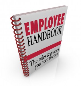 Employee Handbook words on a book cover to illustrate policies, rules, code of conduct, guidelines or other important instructions or protocols to follow on the job at work