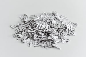 a printed letter or document broken into a thousand pieces