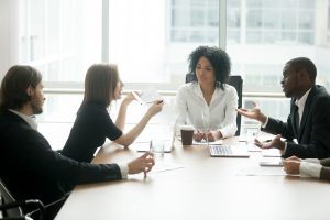 Diverse business partners in group meeting arguing about contract
