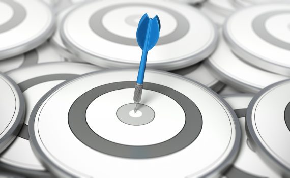 One dart in the center of one target. Many other targets around it. Concept image for illustration of strategy or best choice.